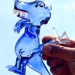 Dinosaur glass bong shaped like a T-rex with hand-blown glass design